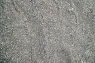 Obraz premium A textured backdrop of fine sand, perfect for use as a background element, isolated in white background. The subtle gradients and patterns create a versatile neutral texture.