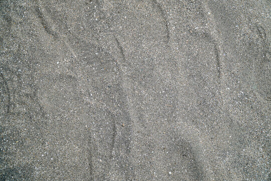 A textured backdrop of fine sand, perfect for use as a background element, isolated in white background. The subtle gradients and patterns create a versatile neutral texture.