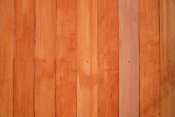 Fototapeta premium Detailed texture of wood grain forming a fence with rustic orange panels, wooden surface brings a touch of nature to architectural designs. Isolated in white background.