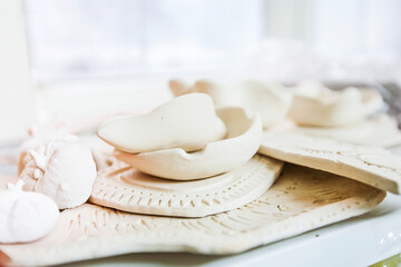Collection of unfired white clay pottery pieces