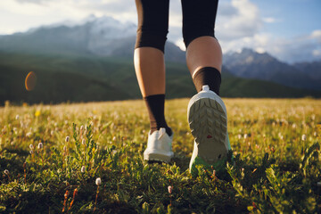 Trail runner running  on the high altitude grassland mountain top