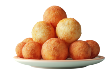 Golden brown puff pastry balls on white plate against black background, cut out
