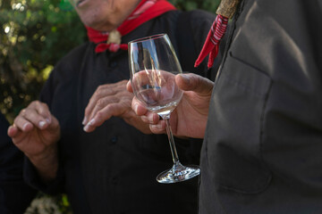 Alentejo singer of traditional 'Cante' wearing boina cap and neck scarf, holding a glass of wine, symbol of Portuguese rural culture.