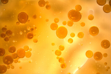 Yellow Oil Bubbles Floating in Liquid Abstract Background