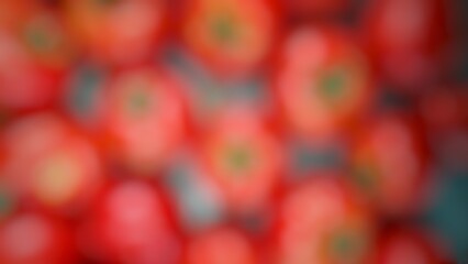 That image is a close-up, blurry shot of many red tomatoes.