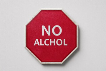 Red octagonal no alcohol sign on a light background