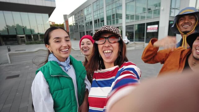 Group of trendy influencer friends taking selfie having fun with with mobile phone app in the city 