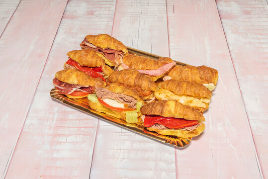 Mini croissants filled with portobello mushrooms sautéed with garlic and thyme, presented in a wicker basket with rosemary sprigs