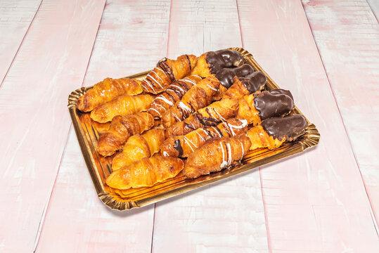 Delicate savory croissants filled with smoked salmon and dill cream cheese, garnished with thin strips of candied lemon