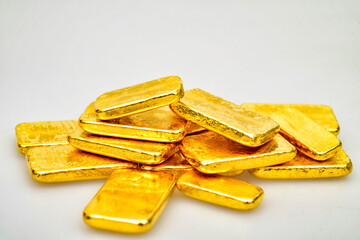Many shiny gold bars on white background
