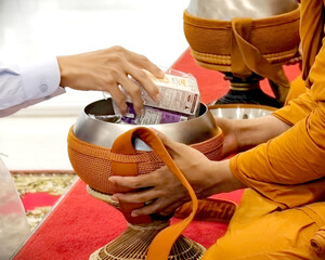 Offering food to monk bowl in Buddhist tradition shows respect and kindness