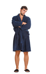 Full length portrait of a displeased young man in bathrobe keeps arms folded, looking aside upset and fatigue, isolated on transparent background