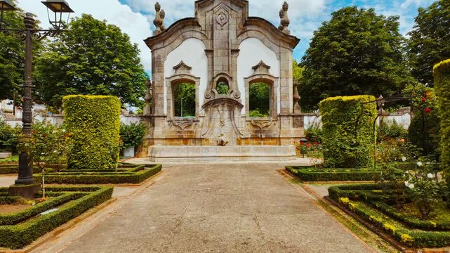 Barrocas Gardens in Barcelos, Portugal offers a calm urban green space with tree lined paths trimmed hedges and seasonal flower beds
