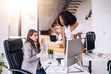 Conflict between coworkers in modern office setting during working hours