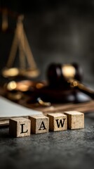 Wooden law blocks with gavel and scales in background symbolizing justice