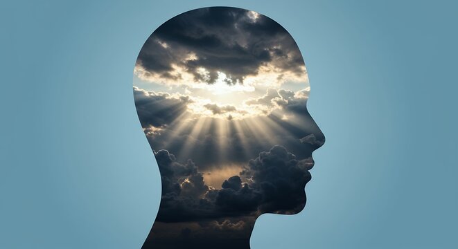 Human head silhouette with radiant light