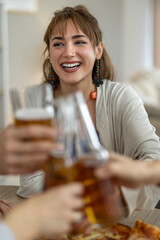 Friends celebrating with drinks and laughter at a cozy gathering in the afternoon