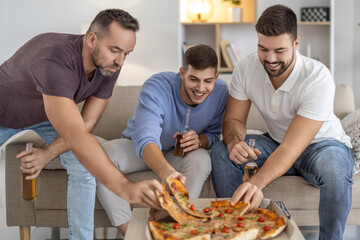 Friends enjoying pizza and drinks at a cozy living room during a casual gathering in the evening
