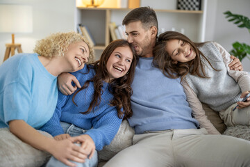 Happy family enjoys cozy moments together at home during a relaxed afternoon in a comfortable living room setting