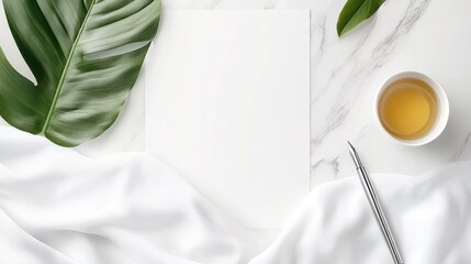 Minimalist Workspace: Blank Paper, Tea, Pen, and Monstera Leaf on Marble