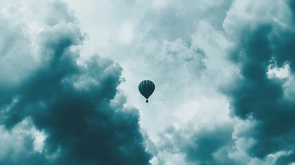 Solitary Hot Air Balloon Ascending Through Dramatic Teal Clouds