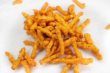 Heap of Crunchy spicy snacks isolated on white background. red chilli powder snack isolated on white background. Indian tea snacks concepts.