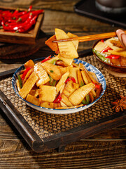 Fresh Bamboo Shoots Stir-Fry with Peppers in Traditional Asian Bowl with Chopsticks