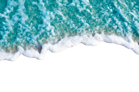 Aerial view of ocean waves crashing on shore with white foam