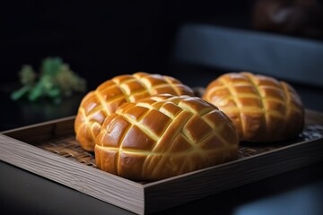 Japanese melon pan sweet bread golden crust crisscross pattern stacked in bakery tray