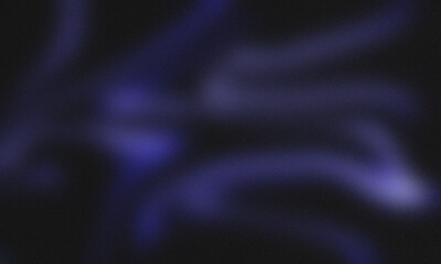 Abstract image featuring blurred purple light streaks against a dark background creating a soft glow