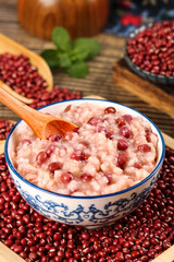 Red Bean Barley Congee Porridge in Traditional Bowl with Raw Grains