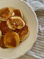 Freshly cooked homemade pancakes on a plate. Golden, fluffy, and ready to serve for breakfast or brunch.