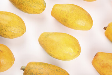 Fresh Yellow Papayas Display on White Background - Tropical Fruit Pattern