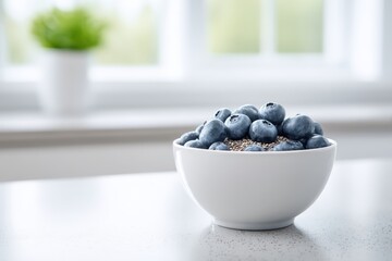 Bowl filled with fresh blueberries and chia seeds placed on a kitchen countertop, surrounded by natural light, showcasing healthy eating and vibrant colors