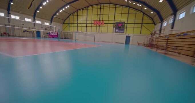 Empty netball practice gym. First person drone flight point of view