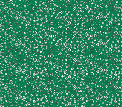 Simple ditsy floral seamless pattern with tiny white folk-style flowers on a green background. Cute and dense vintage print for textile, fabric, or wallpaper. Small botanical design.