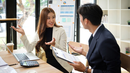 Professional colleagues having an animated conversation during a business meeting.