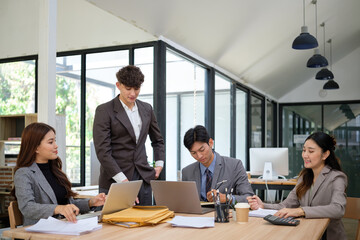 Business professionals collaborating on a project in a bright office.