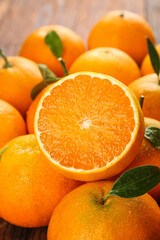 Fresh Orange Citrus Fruit Cut in Half with Green Leaves - Healthy Vitamin C Produce