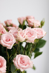 Close-up, bouquet of small pink roses on a white background.