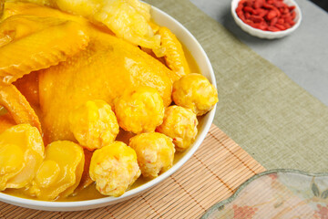 Golden Fish Maw Soup with Chicken Meatballs - Traditional Asian Delicacy in White Bowl