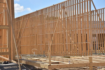 Wood framework of wall braced into place of new commercial building.