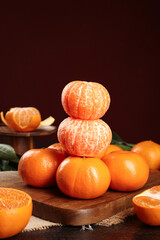 Fresh Citrus Fruit Harvest - Peeled Oranges and Mandarins on Wooden Board