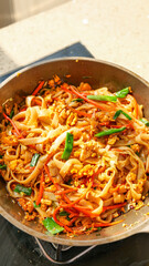Chinese Stir-Fried Rice Noodles with Vegetables in Wok - Traditional Guangxi Vermicelli Cooking