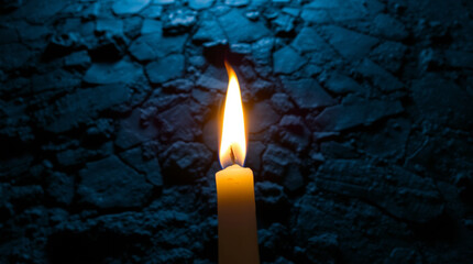 burning candle on black background