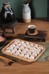 Handmade Goldfish Wonton Dumplings in Bamboo Steamer Ready for Clear Soup Cooking