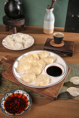 Handmade Seafood Mackerel Dumplings with Soy Sauce on Wooden Table - Traditional Asian Cuisine