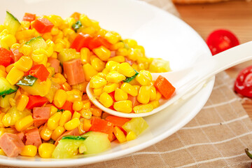 Fresh Corn Kernel Vegetable Salad with Mixed Peppers and Cucumbers on White Plate