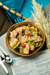 Healthy chicken salad in wooden bowl