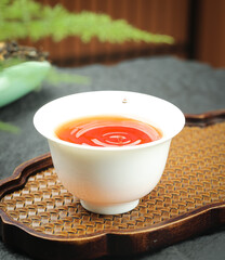 Organic Dahongpao Tea from Yunnan China in Traditional Cup with Bamboo Tray